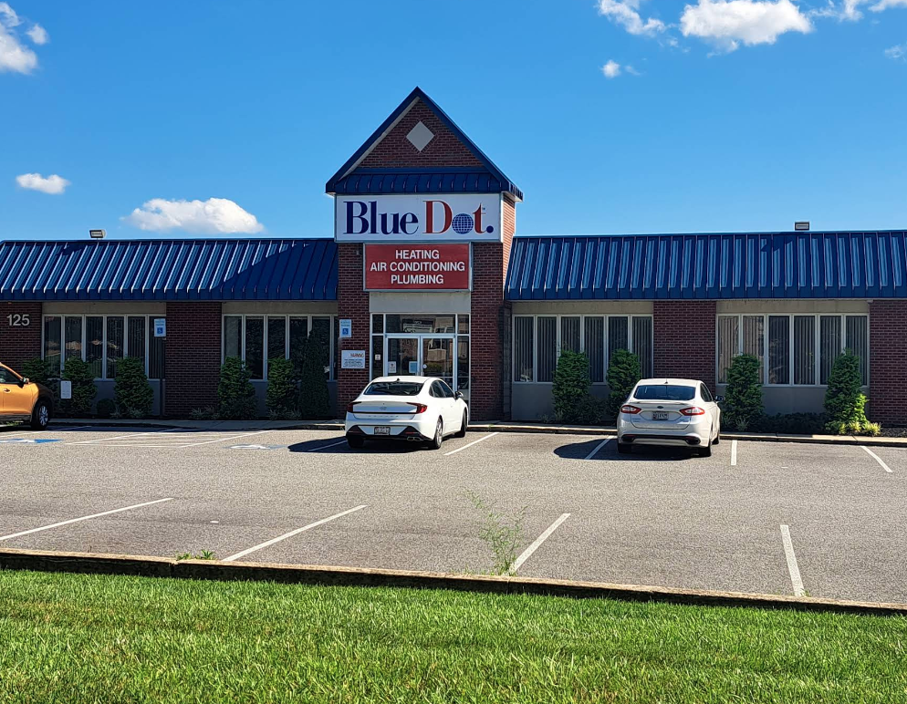  Exterior of Blue Dot office building in Baltimore, MD, with parked cars in the parking lot.