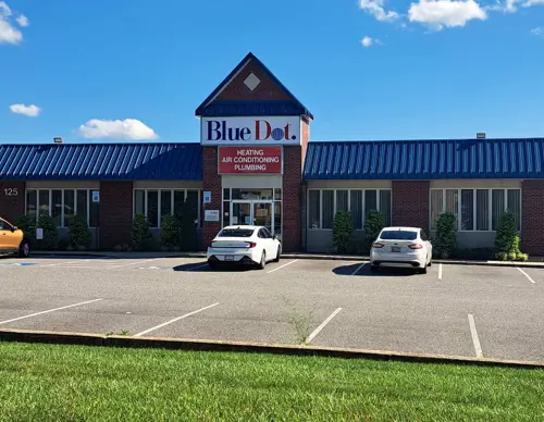 Exterior of Blue Dot office building in Baltimore, MD, with parked cars in the parking lot.
