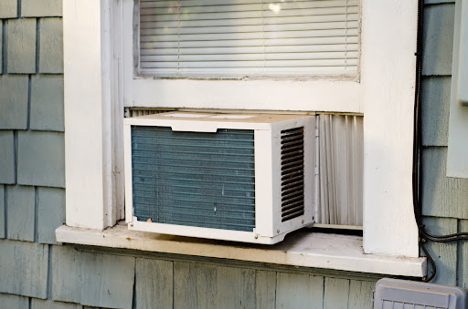 An air conditioning unit sticking out of a window.