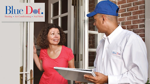 Furnace repair technician visiting with customer at her home about heating repair in Baltimore, MD